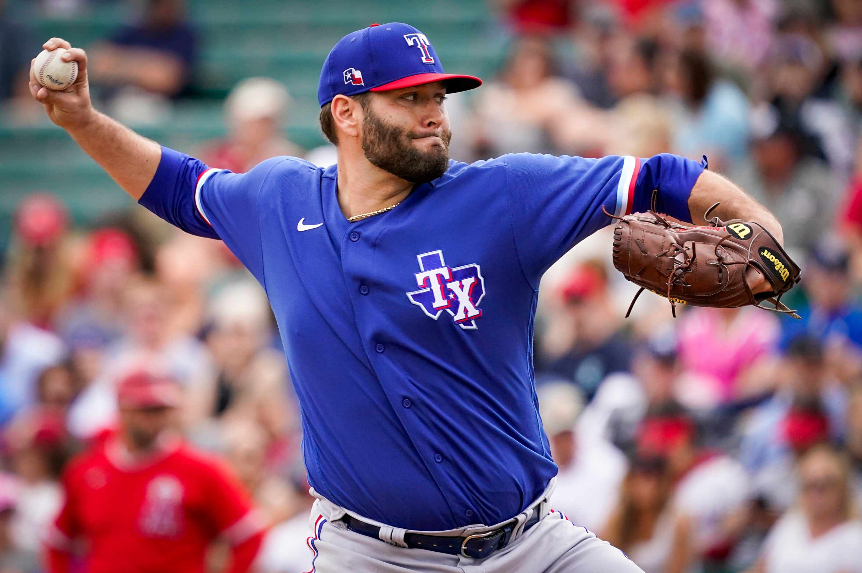 Texas Rangers pitcher Lance Lynn pitches during the first inning of a spring training game...