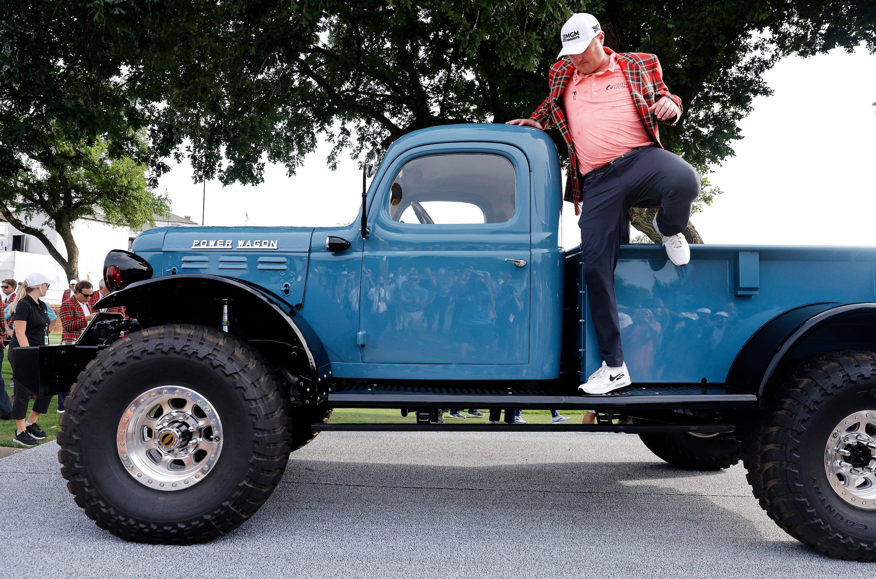 Professional golfer Jason Kokrak climbs off the custom built 1946 Schwab Power Wagon he won...