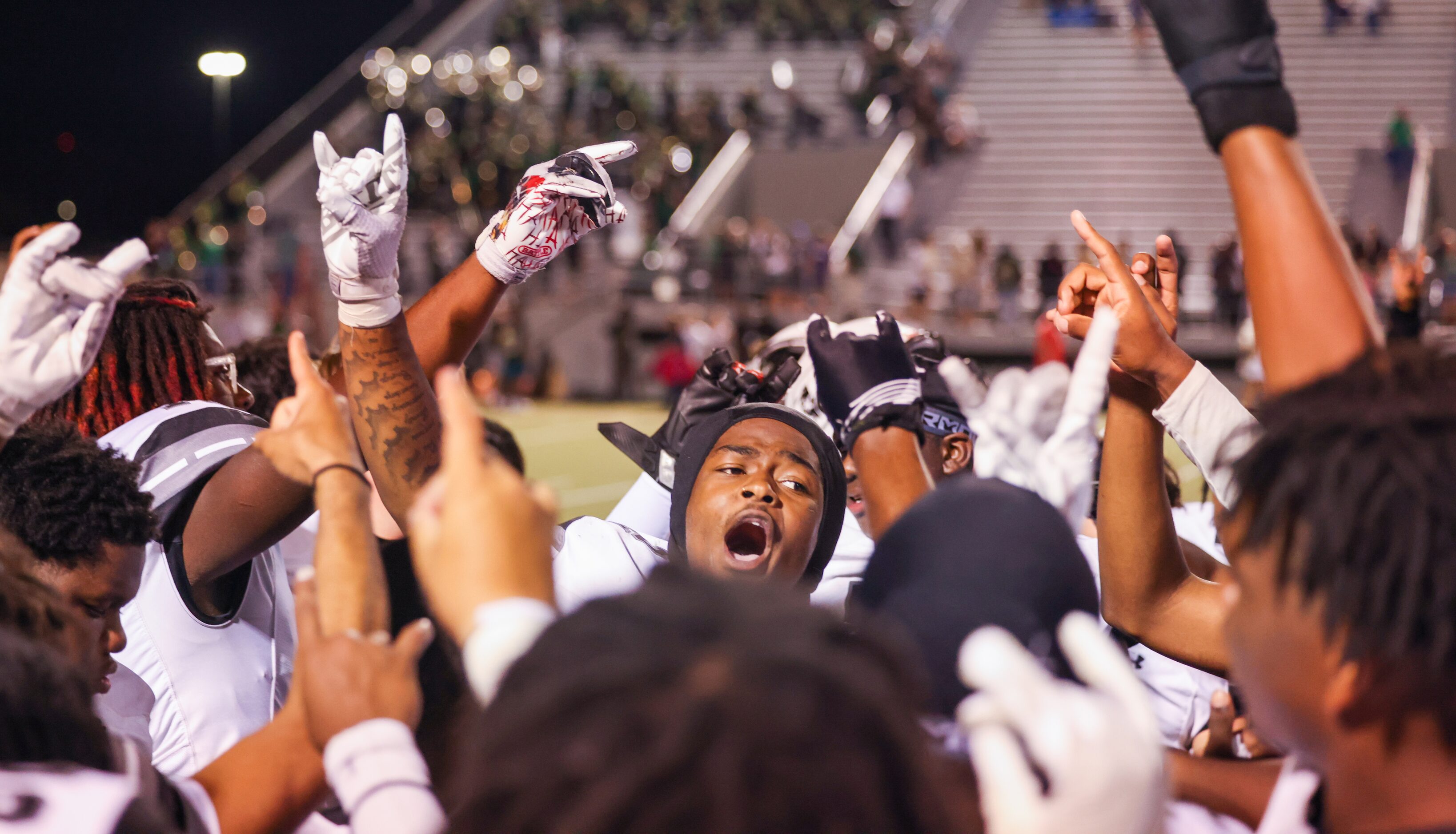 Mansfield Timberview line backer Joel Ardern (2) leads a celebration chant among teammates...