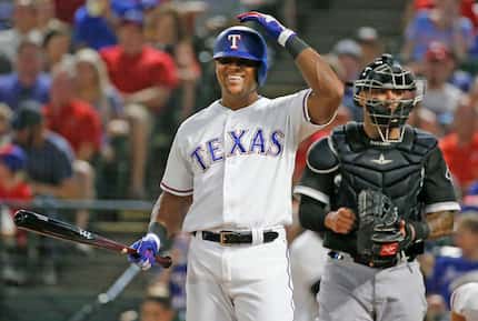 FILE - Adrian Beltre (29) smiles after talking with home plate umpire Joe West during a game...