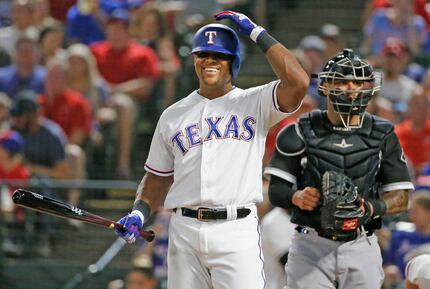 FILE - Adrian Beltre (29) smiles after talking with home plate umpire Joe West during a game...