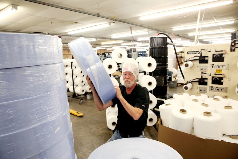 In this 2017 photo, a worker makes medical masks at a Texas plant.