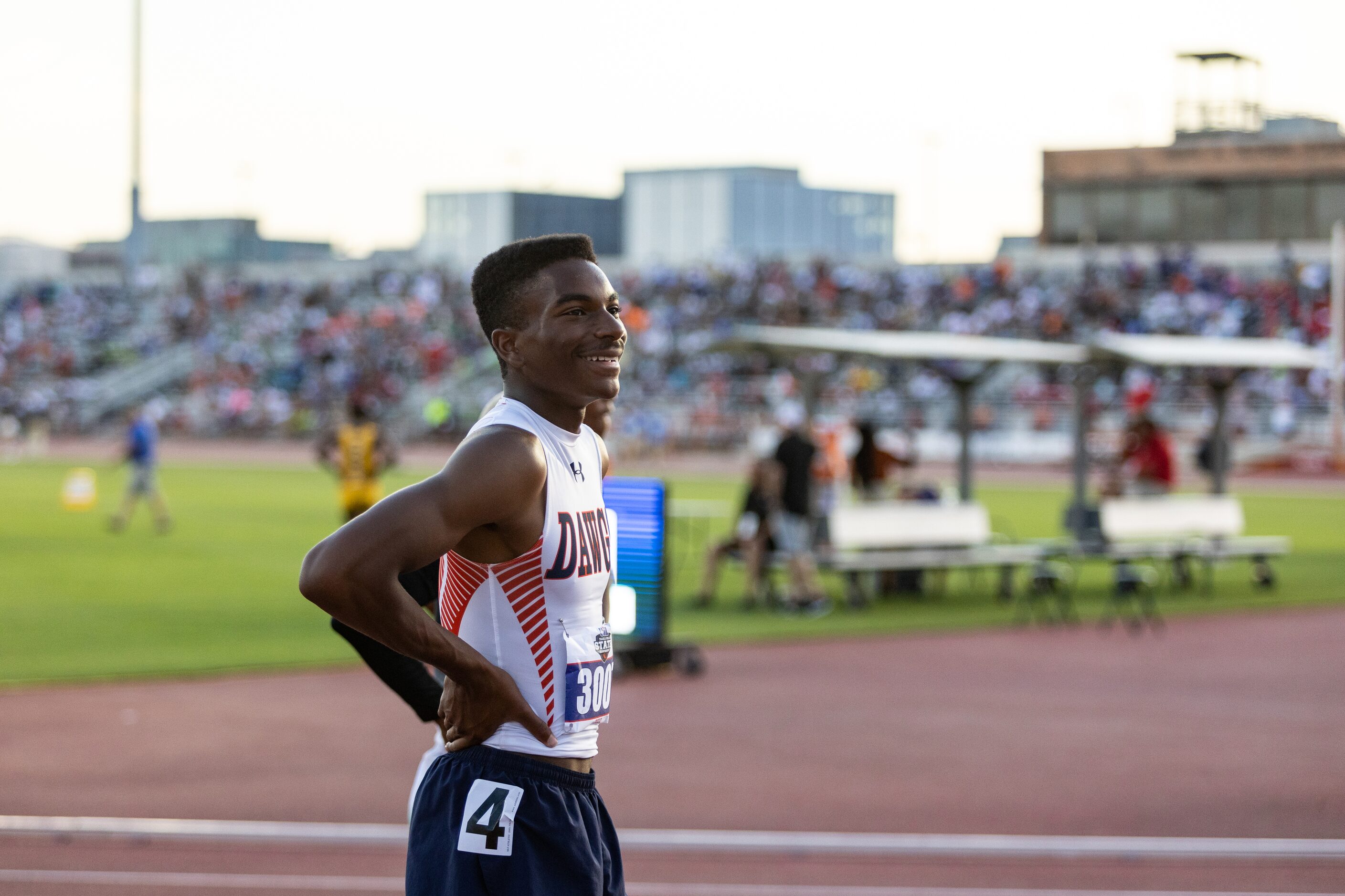 Kody Blackwood of McKinney North smiles at cheering fans after winning the boys’ 300m...