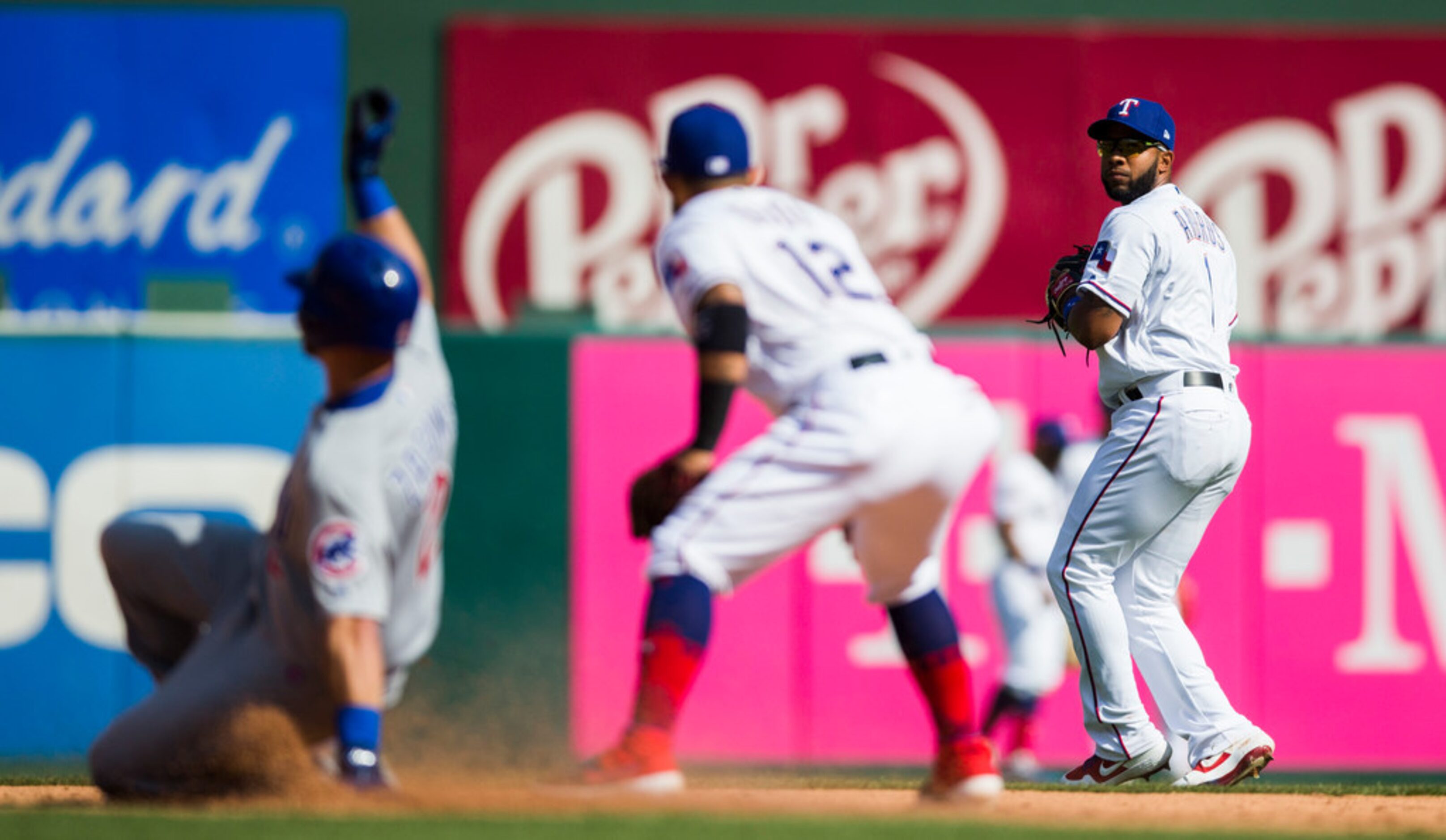 Texas Rangers shortstop Elvis Andrus (1) looks at second baseman Rougned Odor (12) as...