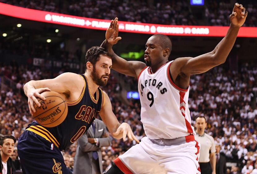 Cleveland Cavaliers forward Kevin Love (0) protects the ball from Toronto Raptors forward...