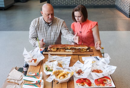 How big is the Boomstick Burger? Rangers beat writer Evan Grant (left) and food reporter...