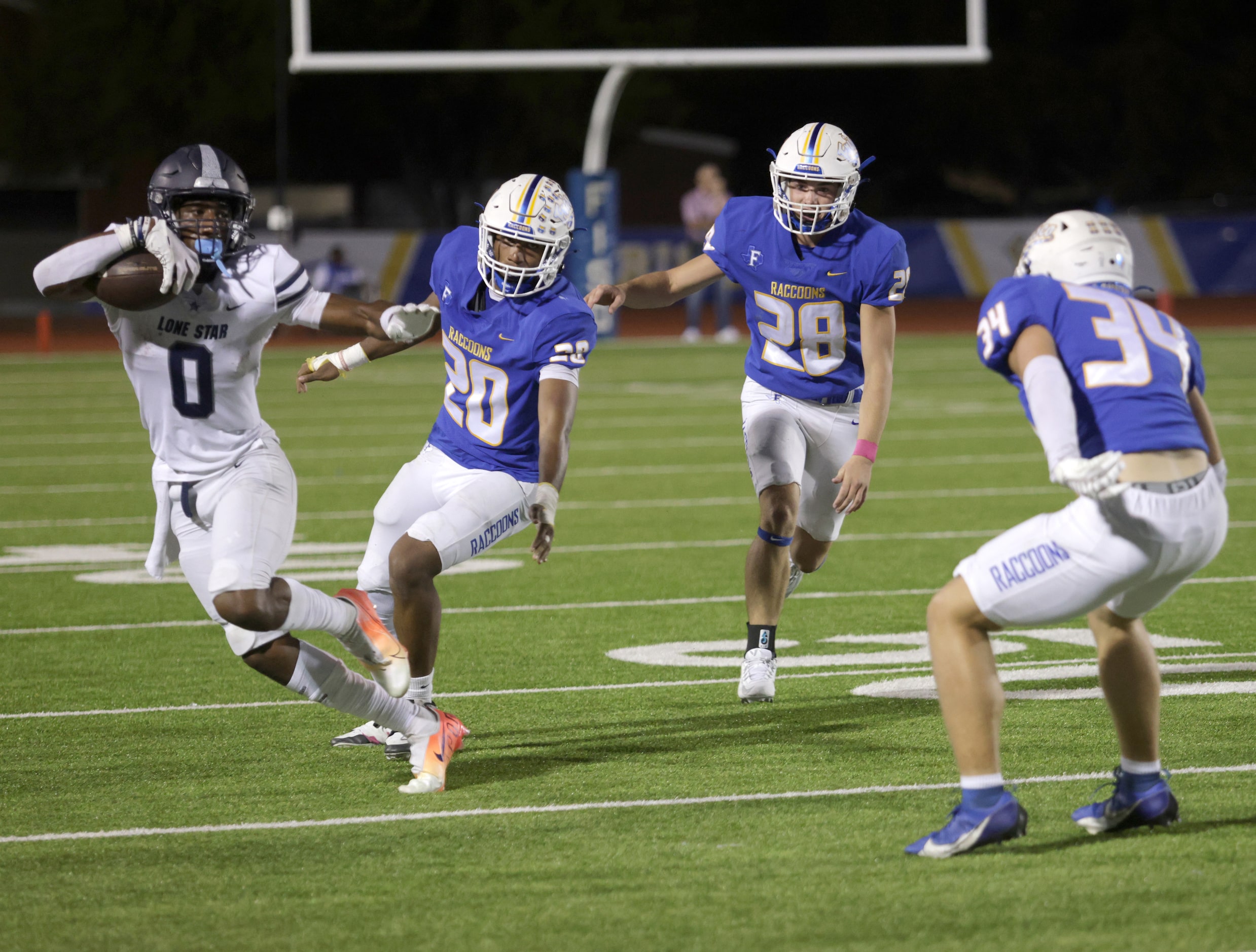 Lone Star player #0 Davian Groce avoids a tackle during the Frisco Lone Star High School...