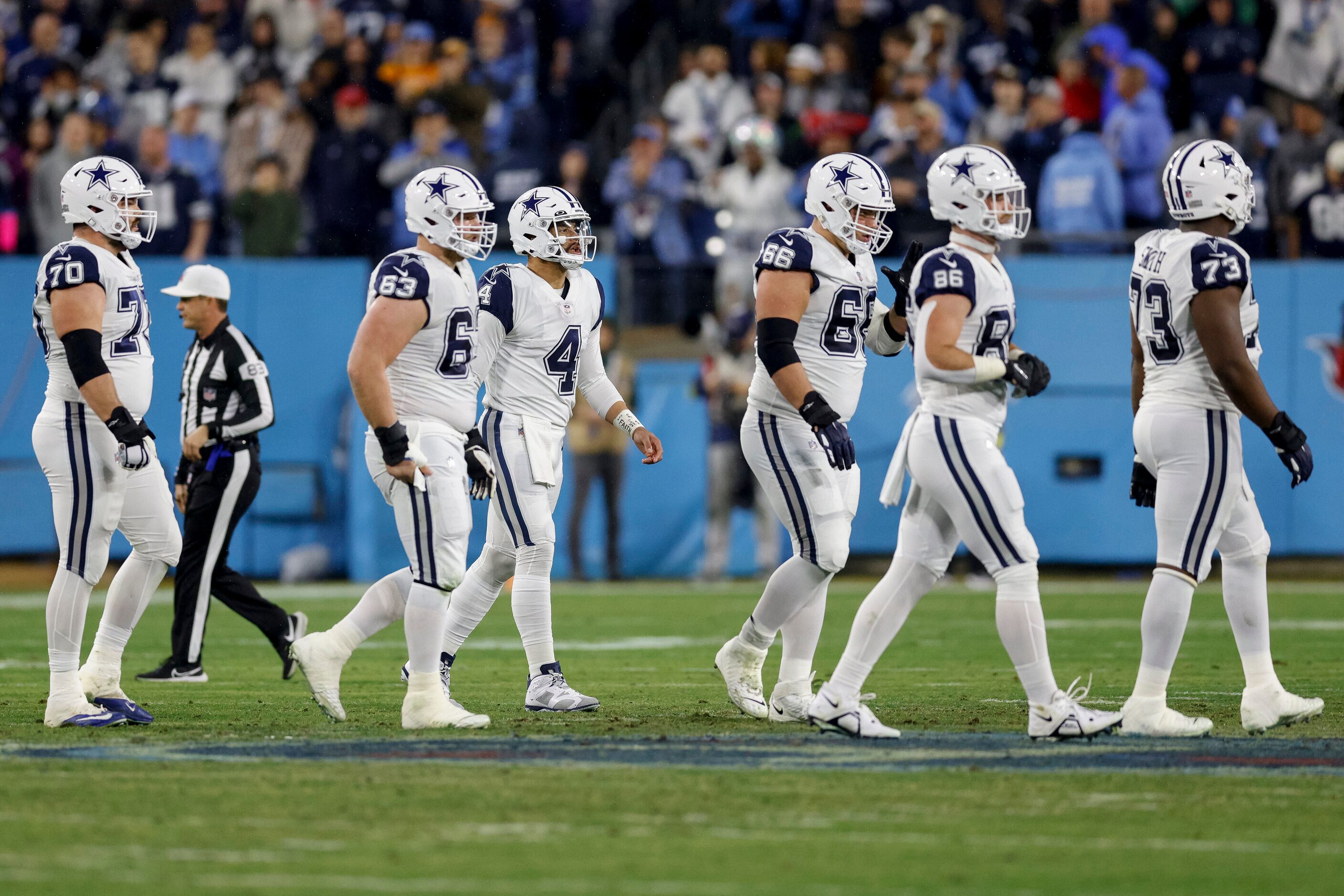 Dallas Cowboys quarterback Dak Prescott (4) and the offensive line walk off the field after...