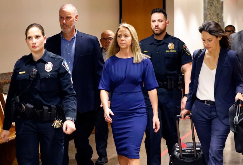 Fired Dallas police Officer Amber Guyger (center) arrives for the first day of her murder...