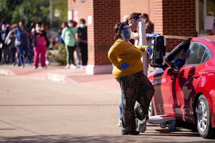 Curbside voting and voters are pictured during the first day of early voting at Disciple...