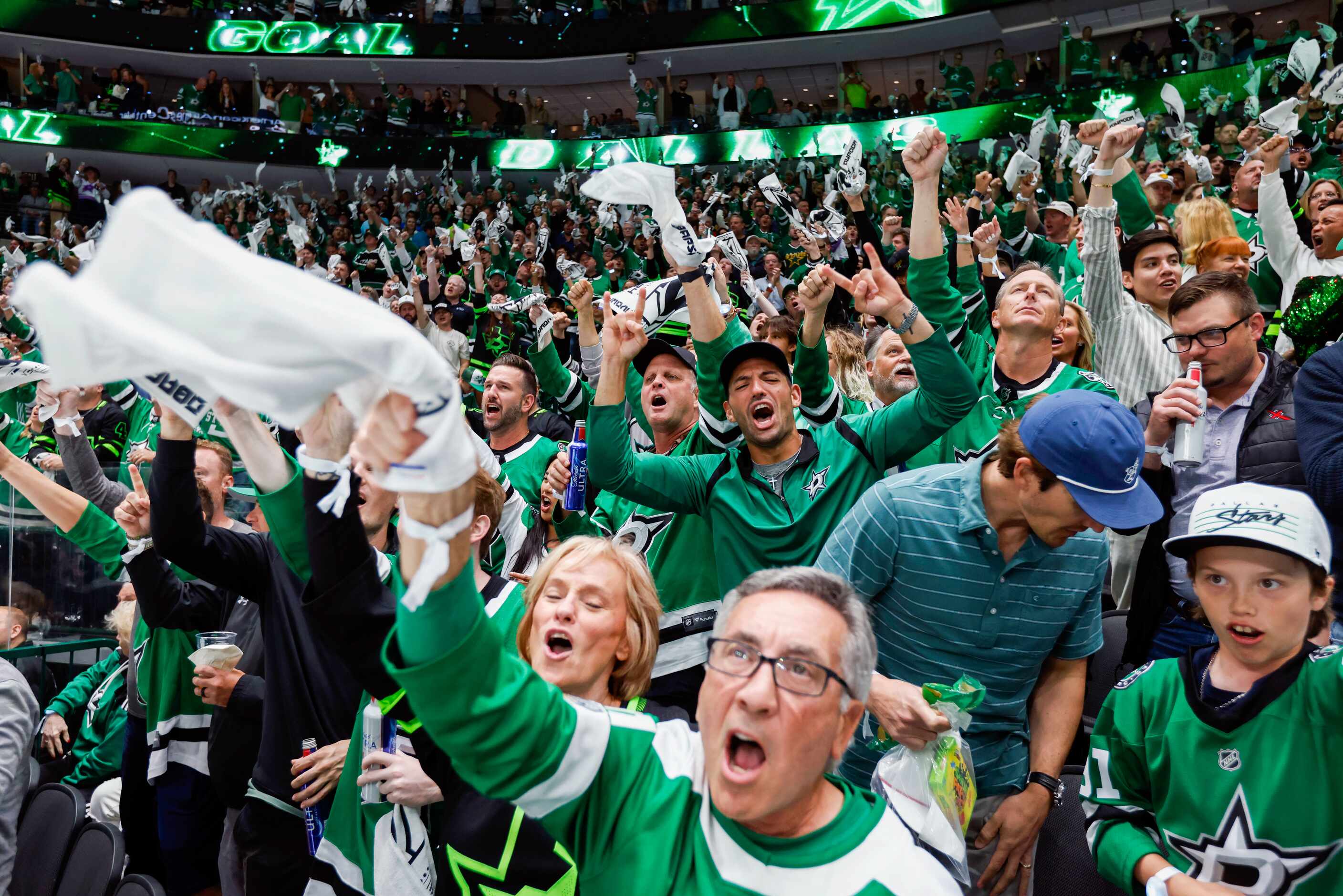 Dallas Stars fan celebrate a goal during the second period of Game 1 of the NHL hockey...