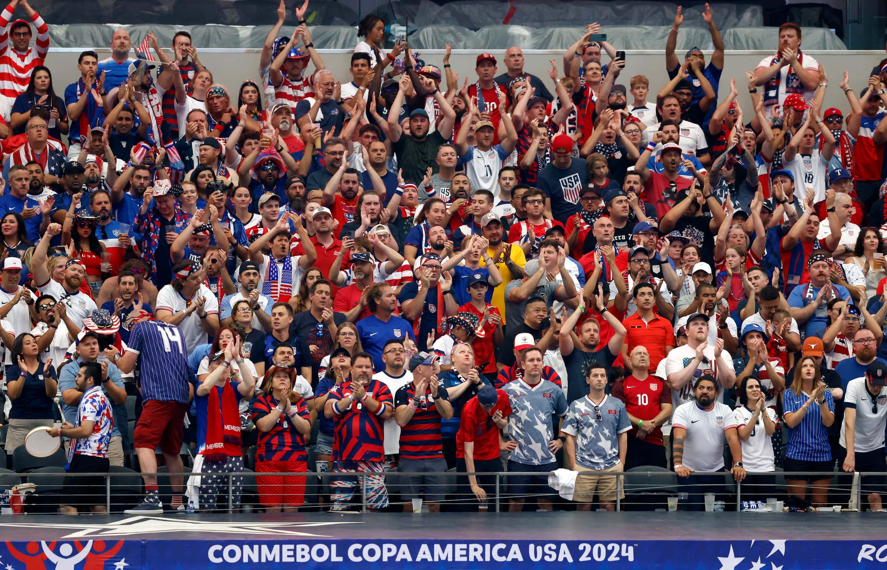 United States soccer fans stand and clap during the first half of a Copa America Group C...