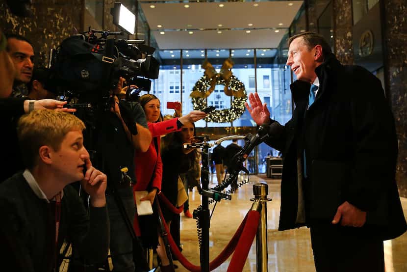 Retired General David Petraeus speaks to members of the media while leaving  Trump Tower in...