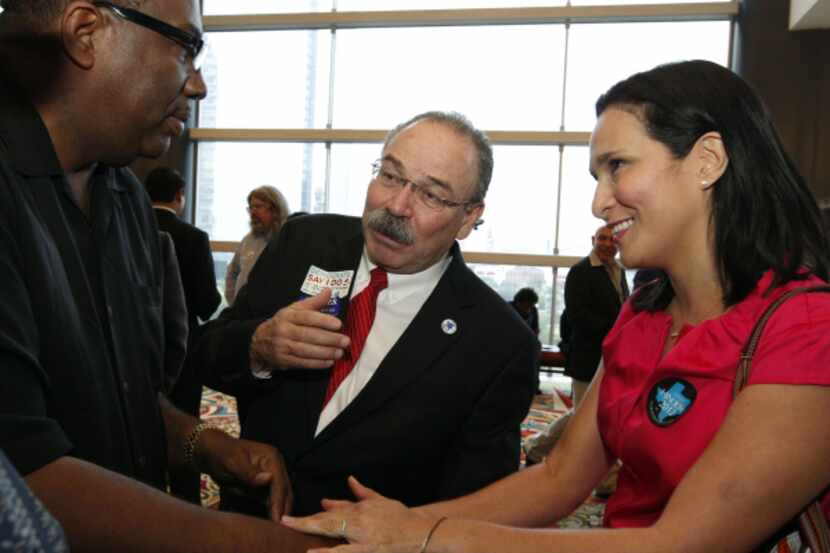 Texas state Sen. Royce West, left, chats with Gilberto Hinojosa and his wife, Cyndi,  before...