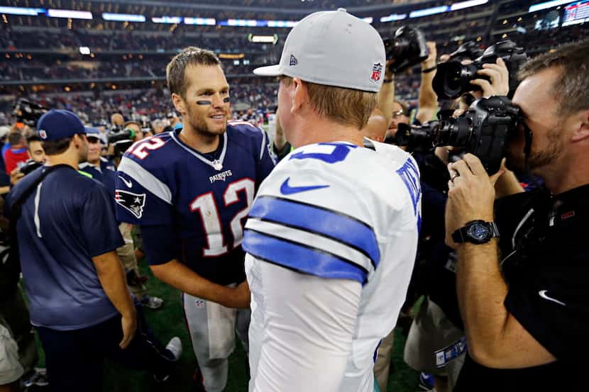 New England Patriots quarterback Tom Brady (12) shakes hands with Dallas Cowboys quarterback...