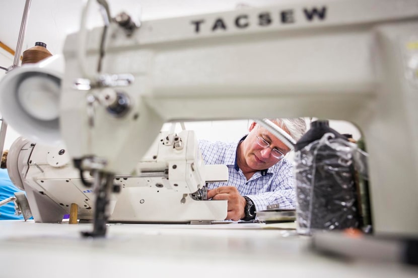 
Scott Mayer repairs a sewing machine at the Erda plant. The company has added ergonomic...