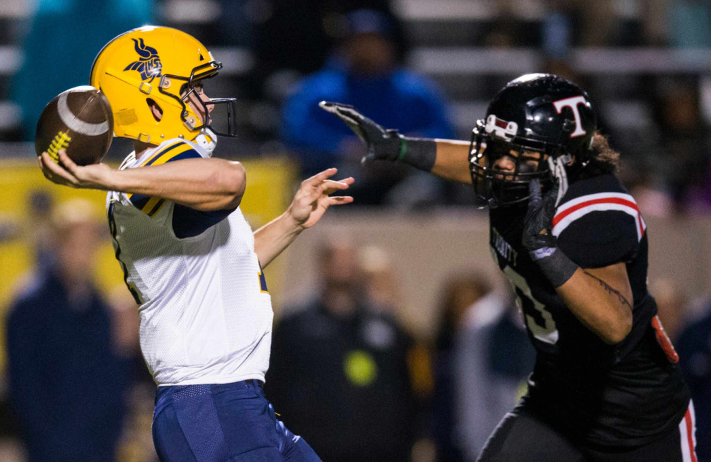 Arlington Lamar quarterback Jack Dawson (7) is threatened by Euless Trinity linebacker...