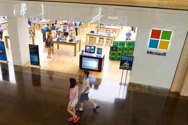  NorthPark Center patrons walk by the Windows store in Dallas, Texas on Wednesday, July, 29,...