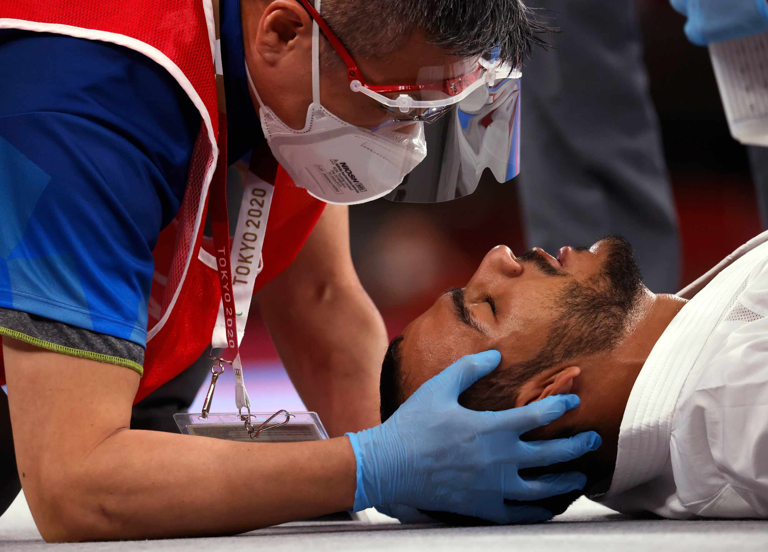 A doctor talks to Egypt’s Abdalla Abdelaziz as he examines him after being hit in a bout...