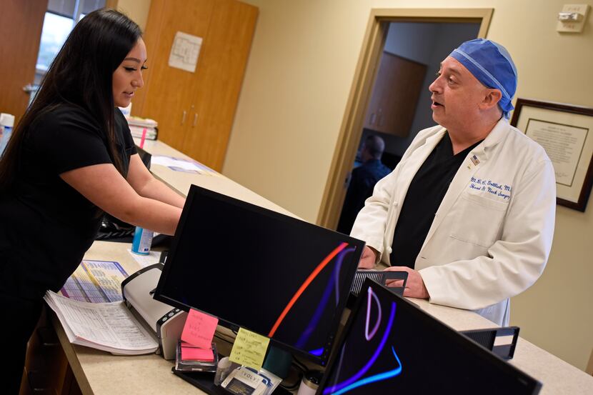 Medical assistant Ana Aguilar, left, speaks with Dr. Morris Gottlieb of North Dallas Ear,...