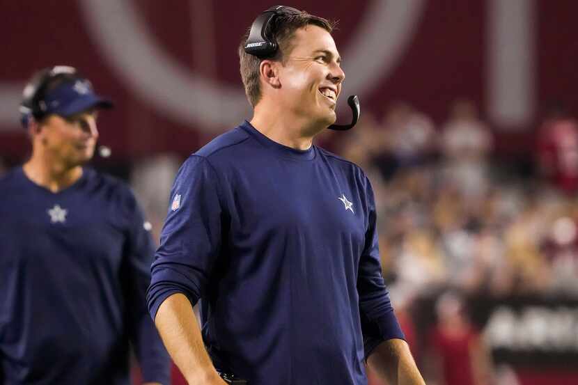 Dallas Cowboys offensive coordinator Kellen Moore smiles on the sidelines during the second...