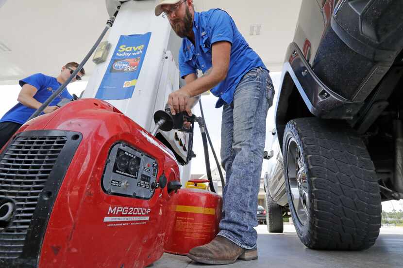 Aaron Berg fills up a gas can and his portable generator in Houston as Hurricane Harvey...