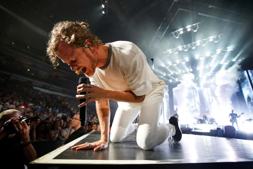 Imagine Dragons lead singer Dan Reynolds performs to an American Airlines Center crowd in...