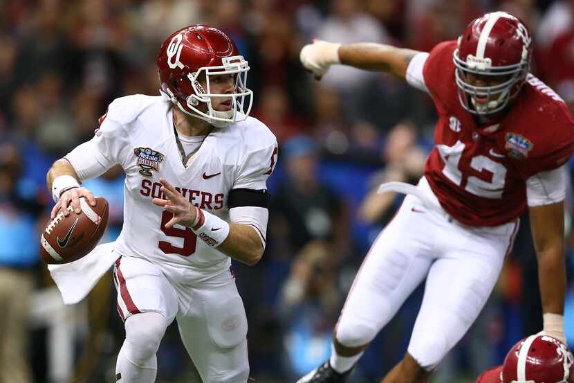 Trevor Knight #9 of the Oklahoma Sooners looks to throw a pass against the Alabama Crimson...