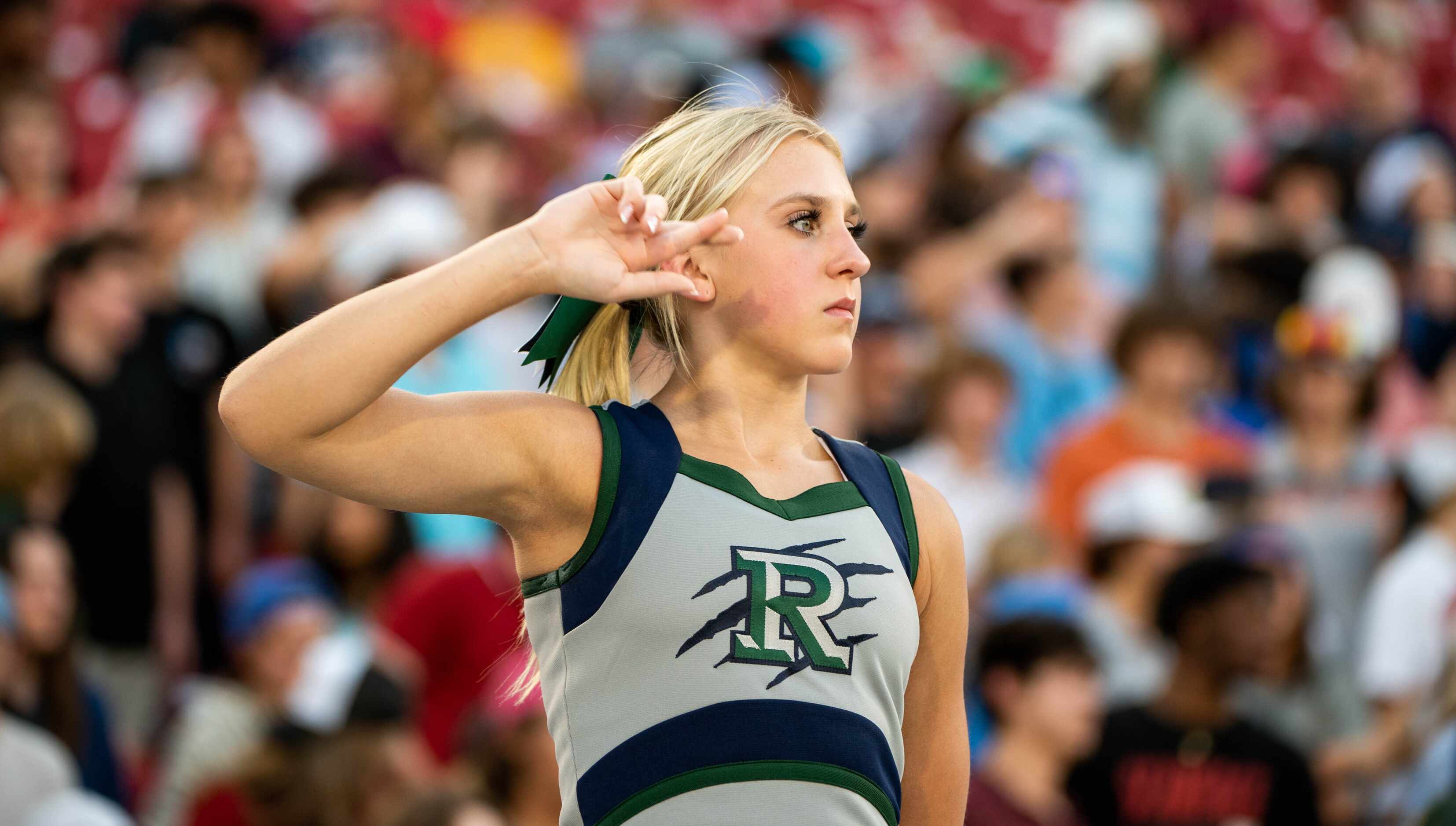 Frisco Reedy's cheerleader waits for the opening kickoff during a high school football game...