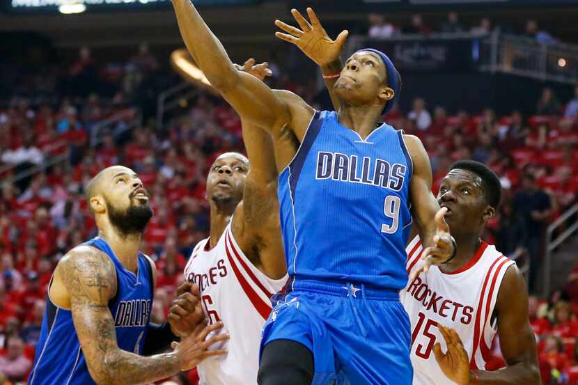 Dallas Mavericks guard Rajon Rondo (9) attempts a laypu in front of Houston Rockets forward...