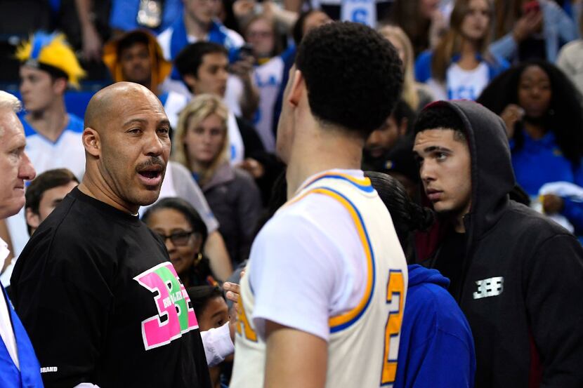 UCLA guard Lonzo Ball, right, shakes hands with his father LaVar following a game against...