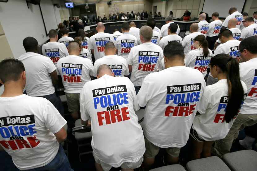 Dallas police and firefighters fill the gallery for a City Council budget meeting at Dallas...