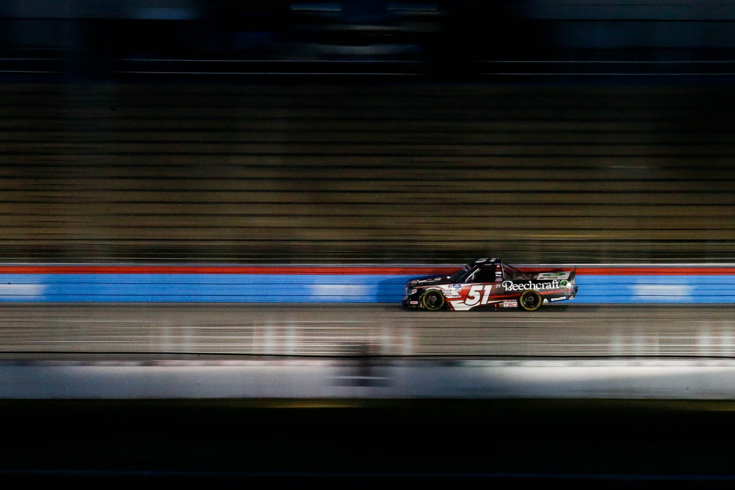 Driver Kyle Busch (No. 51) races during the Vankor 350 NASCAR Gander RV & Outdoors Truck...