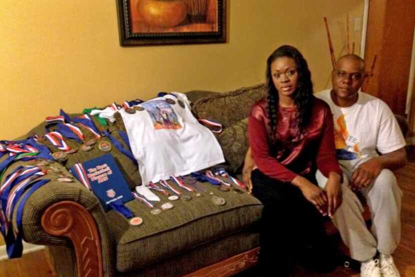 
Tammy and Roferrel Simpson sit next to a makeshift shrine for her son Troy Causey Jr., 18,...