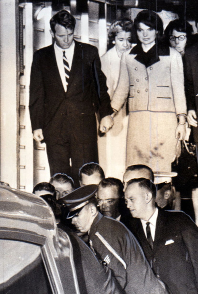 Jacqueline Kennedy, with Attorney General Robert Kennedy, watches the casket of her slain...