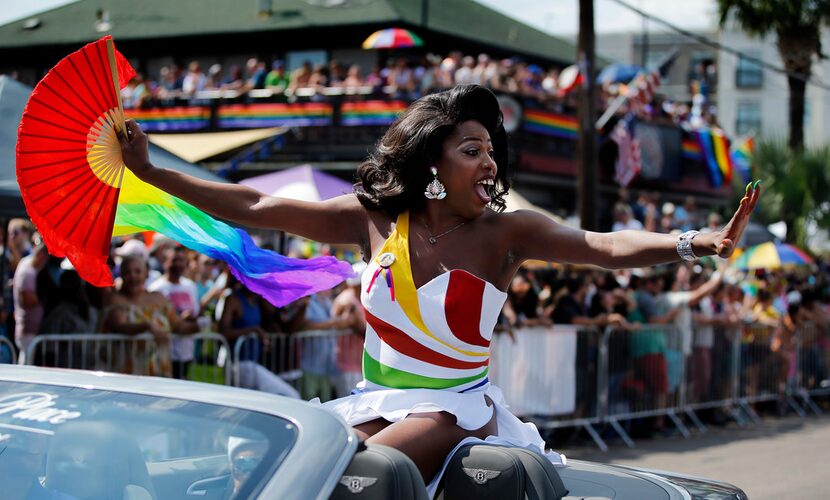 Grand Marshal Nicole O'Hara Munro yells and blows kisses to folks in the crowd during the...