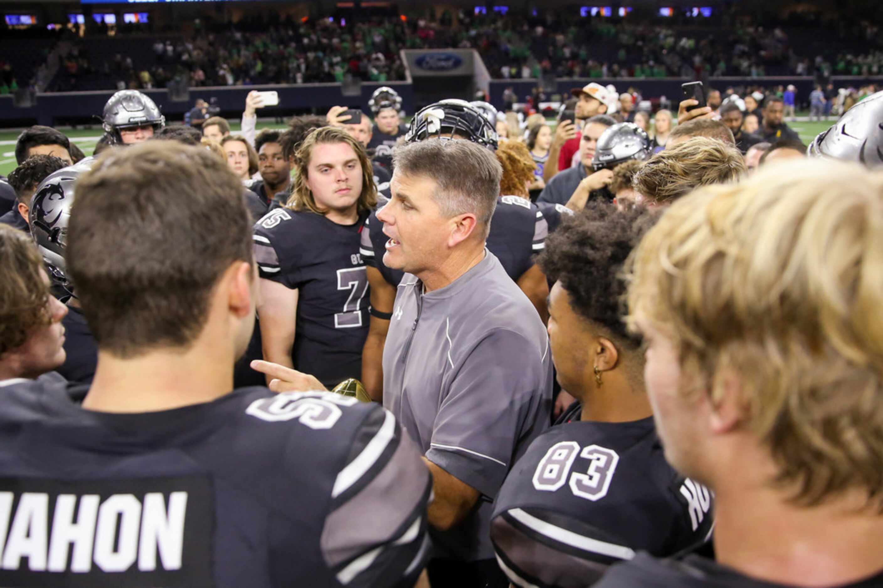 The Denton Guyer Wildcats coach John Walsh gives his team a talk after winning a Class 6A...