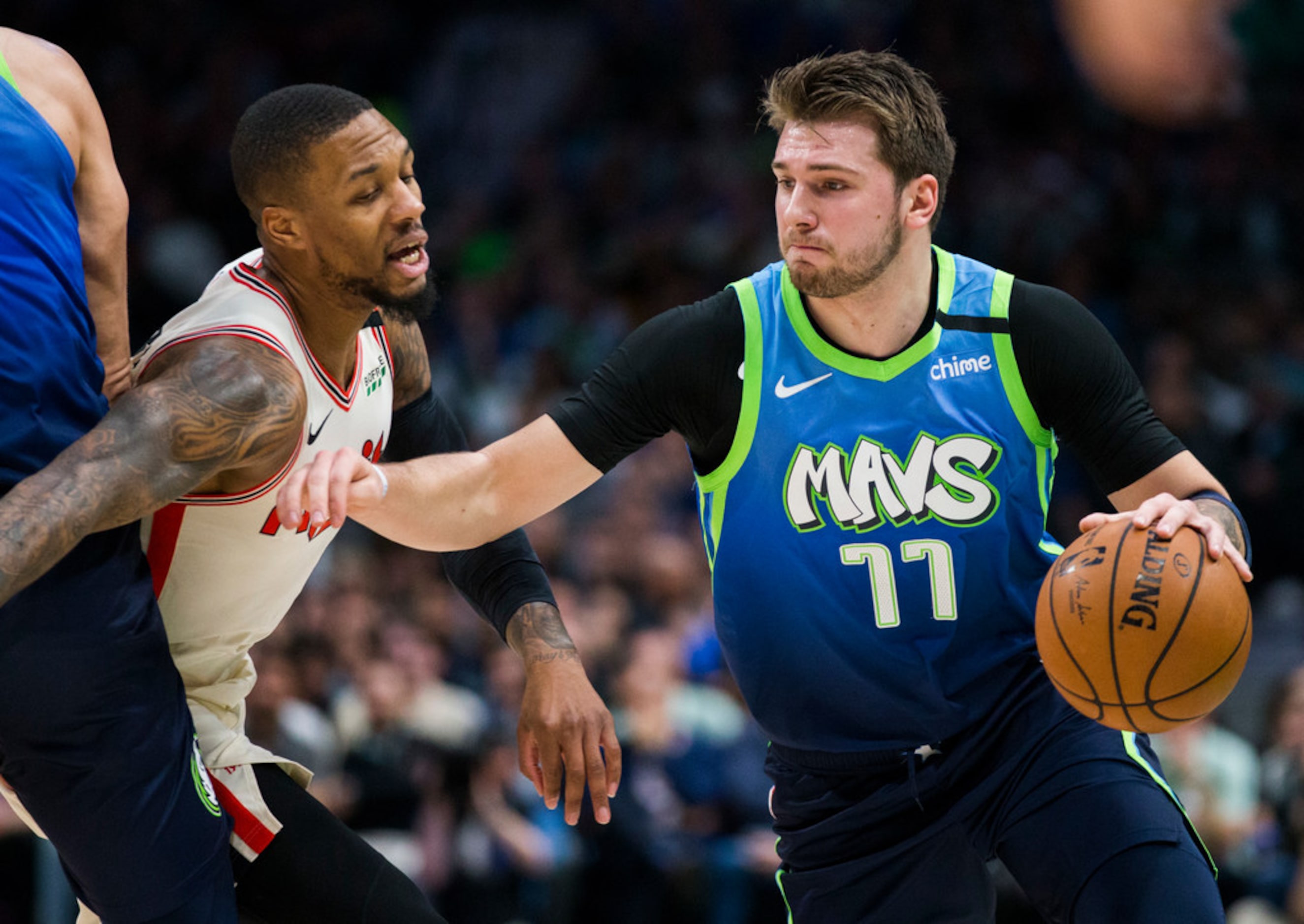 Dallas Mavericks forward Luka Doncic (77) is defended by Portland Trail Blazers guard Damian...