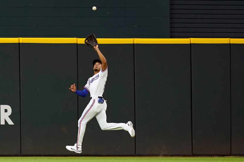 Texas Rangers center fielder Bubba Thompson catches a fly ball hit by Chicago White Sox's...