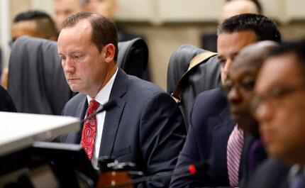 Dallas City Council member Philip Kingston looks at his computer as others members listen to...