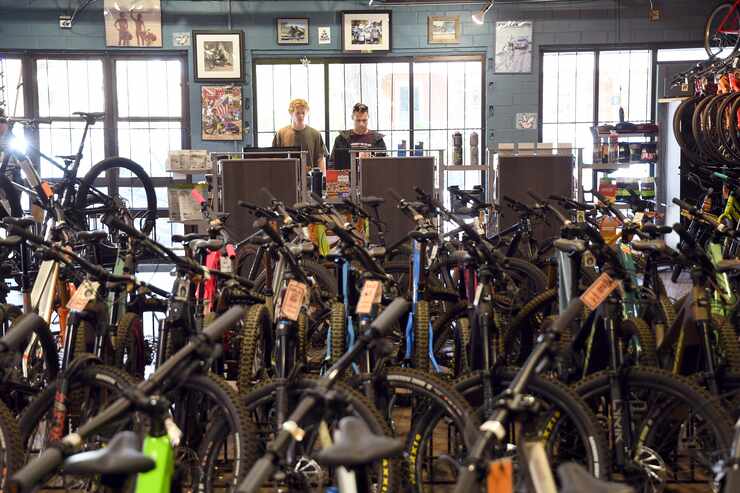Salesmen Will Malfeld, left, and Ben Chandler, right, work at University Bicycles in...