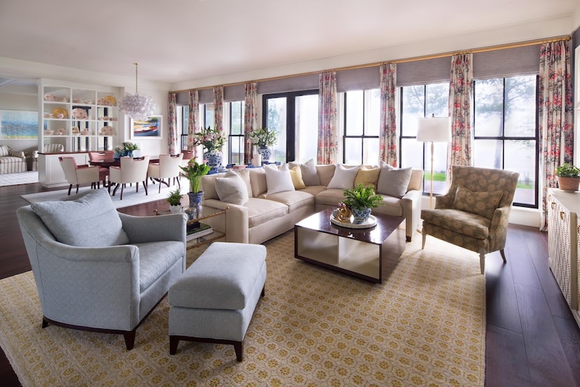 Living room with blue chair, white sectional and yellow patterned rug