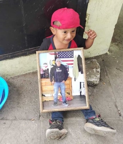 Efraín Xicol Quej's son, Byron, holds a photo of him. Xicol was beaten to death in Dallas on...