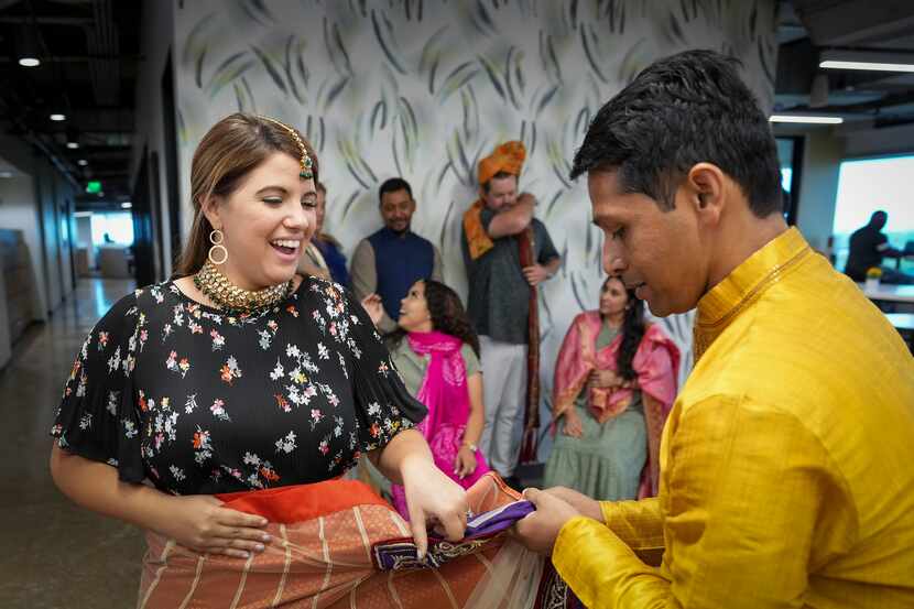 Kaitlyn Osteen dons a sari with the help of Saurabh Bhargava during the Heritage Festival...