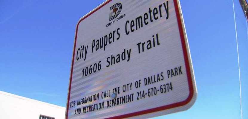 The small sign that marks the entrance to the cemetery off Shady Trail, which is tucked...