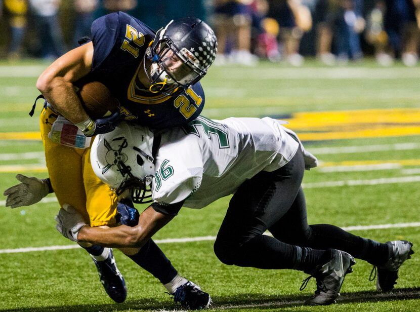 Highland Park running back Jack Kozmetsky (21) is tackled by Mesquite Poteet linebacker...