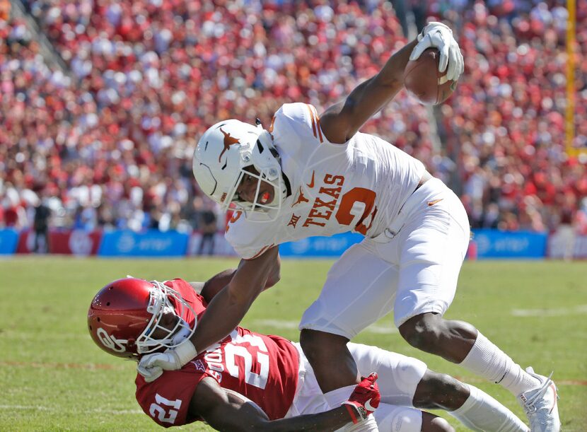 Texas Longhorns wide receiver Devin Duvernay (2) pushes Oklahoma Sooners safety Will...