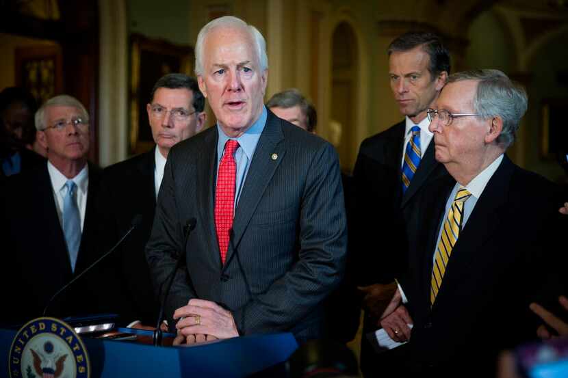  Sen. John Cornyn (center) is a co-sponsor of the Justice Against Sponsors of Terrorism Act,...