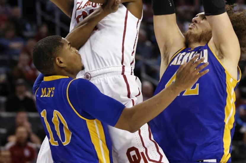 Oklahoma Sooners forward Dante Buford (21) attempts a shot in between Cal State Bakersfield...