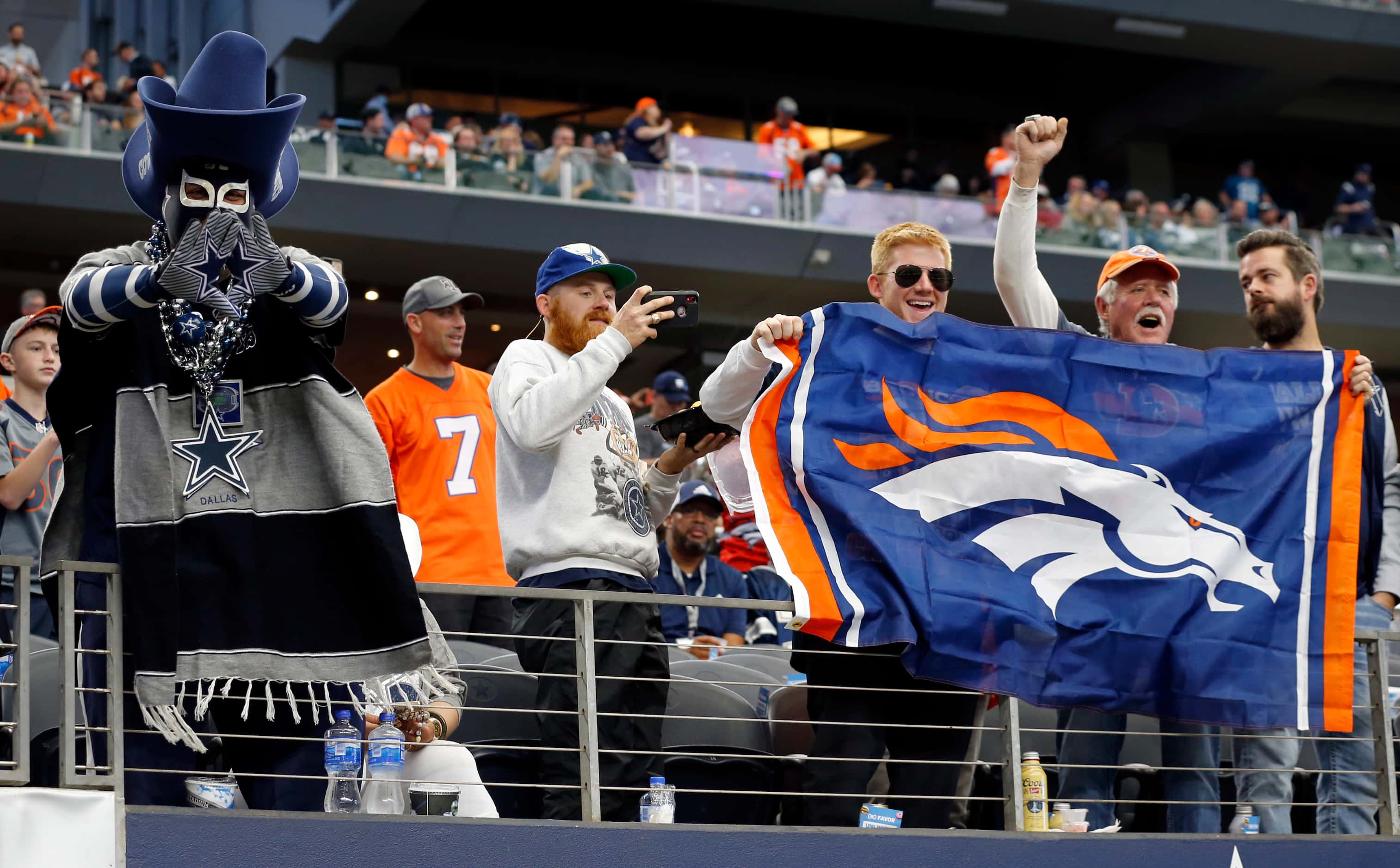 Opposing fans battle in the stands before the first half of a NFL football game between the...